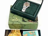rolex watch in a gift box with a map of the world in the background