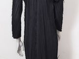 a mannequin wearing a black dress with fringes on it