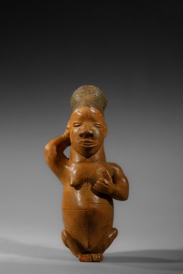 une image représentant une figurine d'un homme portant un chapeau sur la tête