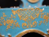 a blue and gold clock sitting on top of a table
