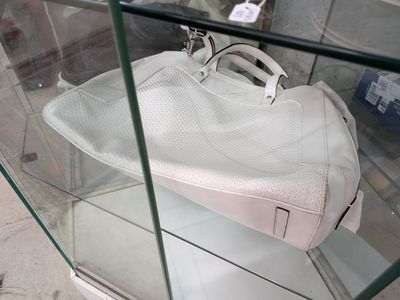 un sac à main blanc exposé dans une vitrine en verre
