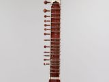 a close up of a musical instrument hanging from a string