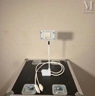 a table that has a laptop and a charger on top of it