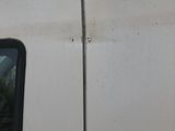 an image of a white van with a cat on top of it