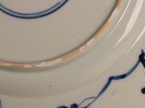 a close up of a plate with a blue and white design