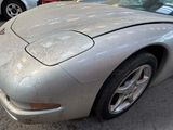 a silver sports car parked on the side of the street