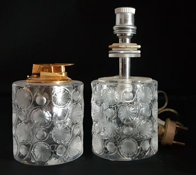 two clear glass bottles with gold lids are sitting next to each other