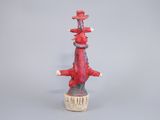 a red sculpture of a bird on top of a pole