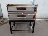 three ovens that are sitting on a stand outside