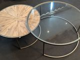 two tables that are sitting next to each other on the floor