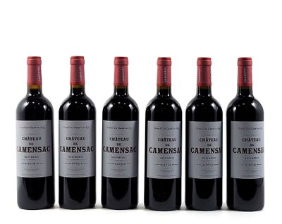 six bottles of wine are lined up in a row on a white surface