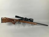 a rifle on a stand with a scope on it