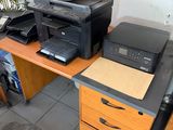 a desk with a printer and a printer on top of it