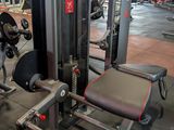 a gym with a row of machines in the middle of the room