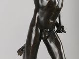 bronze statue of a woman holding a bird in her hand