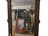 a mirror with a man standing in front of it
