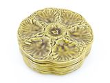 an image of a gold plate with a flower design on it