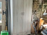 a refrigerator in the middle of a room with a lot of wood