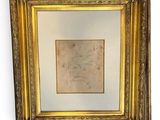 an old picture of a gold frame with a drawing on it