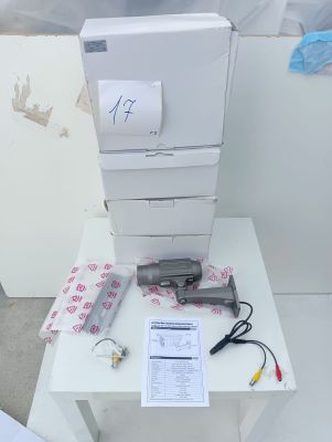 a stack of printers sitting on a table next to a printer