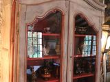 a cabinet that has a glass door on top of it