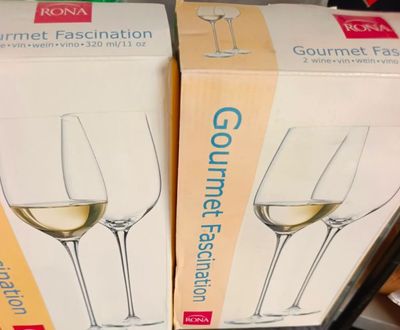 two boxes of wine glasses sitting on top of a table