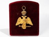 an image of a gold eagle with a crown on it ' s head