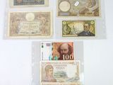 many different types of currency on display on the wall