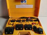 an open yellow case with a bunch of electrical equipment in it