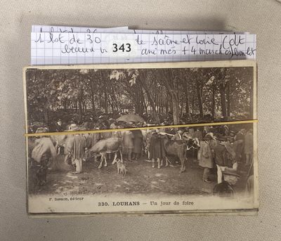 an old black and white photo of a group of people with horses