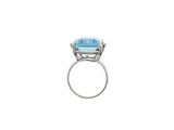 a close up of a ring with a blue topaz stone