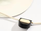 a white hat and a black object on a white table