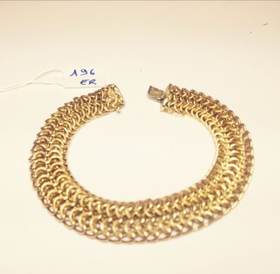 an image of a gold chain bracelet on a white surface