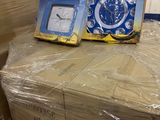 a pile of boxes with a clock on top of it