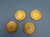 four gold coins, one of which is a lion head and the other of which is a lion head