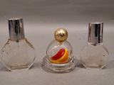 three perfume bottles sitting on top of a table