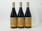 three bottles of wine sitting on top of a white table