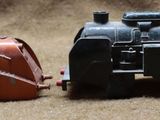 two toy trains sitting next to each other on a table