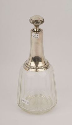 a silver and glass bottle with a stopper on a white background