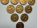 a bunch of gold coins sitting on top of a white surface
