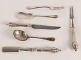 a lot of silver spoons and forks on the table