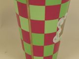 a green and red cup with a teddy bear on it