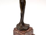 an image of a bronze statue of a woman on a marble base