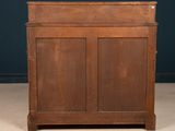 an old wooden cabinet with two doors and a drawer on top of it