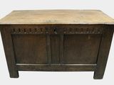 an old wooden chest with two doors and a drawer on top of it