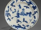 an antique blue and white plate with birds and flowers on it