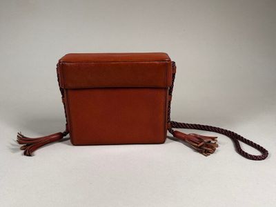 an image of a small brown purse with tassels on it