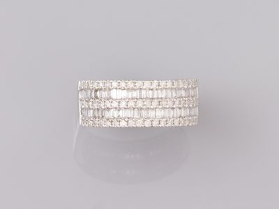 a white gold ring with baguets of diamonds