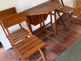 chairs and a table in a room with a rug on the floor