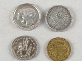 three different types of coins sitting on top of a white surface
